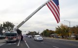 Officer Jonathan Diaz made his final patrol down Hanford Armona Road Thursday afternoon on his way to St. Peter's Catholic Church. 